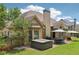 This house has a backyard with a patio set and hot tub on a manicured lawn at 895 Mill Garden Pl, Cumming, GA 30040