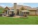 Backyard area with patio, hot tub, and manicured lawn at 895 Mill Garden Pl, Cumming, GA 30040