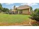 Spacious backyard with lush green grass, landscaping, and a patio area with hot tub at 895 Mill Garden Pl, Cumming, GA 30040