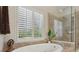 Modern bathroom with a separate shower and tub, featuring ceramic tile at 895 Mill Garden Pl, Cumming, GA 30040