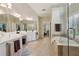 Elegant bathroom with a soaking tub, glass shower, and double vanity sinks at 895 Mill Garden Pl, Cumming, GA 30040
