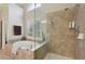 Modern bathroom with a separate shower and tub, featuring ceramic tile at 895 Mill Garden Pl, Cumming, GA 30040