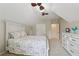 Bright bedroom with carpet, a large bed, ceiling fan, and plenty of closet space at 895 Mill Garden Pl, Cumming, GA 30040