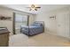 Neutral bedroom with carpet, simple bed, ceiling fan, and a window for natural light at 895 Mill Garden Pl, Cumming, GA 30040