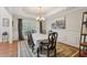 Formal dining room featuring hardwood floors, large windows, and elegant chandelier at 895 Mill Garden Pl, Cumming, GA 30040