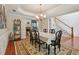 Dining room with hardwood floors, decorative chandelier, and view to a fireplace at 895 Mill Garden Pl, Cumming, GA 30040