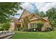 Charming two-story home with lush landscaping, brick accents, and attached two car garage at 895 Mill Garden Pl, Cumming, GA 30040