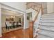 Elegant foyer featuring hardwood floors, staircase, and formal dining room entrance at 895 Mill Garden Pl, Cumming, GA 30040