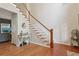 Welcoming foyer with hardwood floors, staircase, and decorative console table at 895 Mill Garden Pl, Cumming, GA 30040