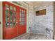 Charming front entrance with double red doors, brick facade, and outdoor seating at 895 Mill Garden Pl, Cumming, GA 30040