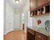 Hallway with built-in desk, storage cabinets, and access to a bathroom at 895 Mill Garden Pl, Cumming, GA 30040