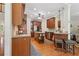 Well-equipped kitchen featuring stainless steel appliances, wooden cabinets, and a central island at 895 Mill Garden Pl, Cumming, GA 30040