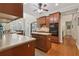 Bright kitchen with wood cabinets, center island and adjacent breakfast area with natural light at 895 Mill Garden Pl, Cumming, GA 30040