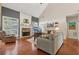 Bright living room boasts hardwood floors, a cozy stone fireplace, and large windows at 895 Mill Garden Pl, Cumming, GA 30040
