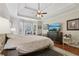 Serene main bedroom with tray ceiling, bay window, and dark wood furniture at 895 Mill Garden Pl, Cumming, GA 30040