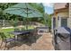 Outdoor patio area with dining set, hot tub, and lush green landscaping at 895 Mill Garden Pl, Cumming, GA 30040