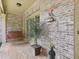 Covered porch featuring brick flooring, hanging swing, and decorative accents at 895 Mill Garden Pl, Cumming, GA 30040