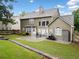 Landscaped backyard with patio, well-kept lawn, storage shed, and mature trees at 977 Frog Leap Trail Nw, Kennesaw, GA 30152