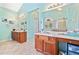 Well-lit bathroom with double vanity, large mirrors, tile floor, and combined shower/tub at 977 Frog Leap Trail Nw, Kennesaw, GA 30152