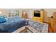 Bright bedroom featuring hardwood floor, a patterned rug, and a custom TV cabinet at 977 Frog Leap Trail Nw, Kennesaw, GA 30152