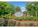 Lakes of Stonegate entrance sign surrounded by landscaping and mature trees at 977 Frog Leap Trail Nw, Kennesaw, GA 30152