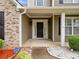 Inviting front entrance featuring a covered porch and manicured shrubbery for a welcoming curb appeal at 977 Frog Leap Trail Nw, Kennesaw, GA 30152