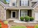 Inviting front entrance featuring a covered porch and manicured shrubbery for a welcoming curb appeal at 977 Frog Leap Trail Nw, Kennesaw, GA 30152
