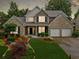 Charming two-story home featuring a brick facade, well-manicured lawn, and a two-car garage at 977 Frog Leap Trail Nw, Kennesaw, GA 30152