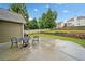 Back patio with table and chairs, well-kept lawn, and landscaped garden beds at 977 Frog Leap Trail Nw, Kennesaw, GA 30152
