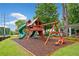 View of the wooden neighborhood playground, featuring slides, swings and climbing structures at 977 Frog Leap Trail Nw, Kennesaw, GA 30152