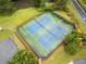 Aerial view of community tennis courts surrounded by lush landscaping at 977 Frog Leap Trail Nw, Kennesaw, GA 30152