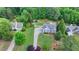 Aerial view of a well-kept home with lush landscaping, long driveway, and private backyard at 1818 Mcconnell Rd, Grayson, GA 30017