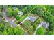 An aerial view shows a charming home with blue shutters and a lush, landscaped yard at 1818 Mcconnell Rd, Grayson, GA 30017
