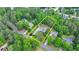 This aerial view highlights the mature trees and well-maintained landscaping surrounding this home at 1818 Mcconnell Rd, Grayson, GA 30017