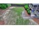 A partially grassed backyard features manicured hedges and a concrete patio outside a screened in porch at 1818 Mcconnell Rd, Grayson, GA 30017