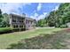 Beautiful backyard with lush green lawn, screened in porch, and mature trees offering privacy at 1818 Mcconnell Rd, Grayson, GA 30017
