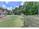 The backyard has a lush lawn, shed, and white picket fence, great for outdoor activities and storage at 1818 Mcconnell Rd, Grayson, GA 30017