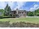 Back of home featuring a screened in porch and well manicured lawn on a sunny day at 1818 Mcconnell Rd, Grayson, GA 30017