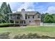 Expansive backyard featuring a screened porch and white picket fence, perfect for outdoor enjoyment at 1818 Mcconnell Rd, Grayson, GA 30017