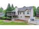 A screened porch, concrete patio, manicured hedges, and a grass lawn enhance this home's backyard at 1818 Mcconnell Rd, Grayson, GA 30017