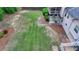 A partially grassed backyard features manicured hedges and a concrete patio outside a screened in porch at 1818 Mcconnell Rd, Grayson, GA 30017