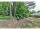Charming seating area in backyard with lush greenery and mature trees creating a serene outdoor setting at 1818 Mcconnell Rd, Grayson, GA 30017
