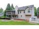 A screened porch, concrete patio, manicured hedges, and a grass lawn enhance this home's backyard at 1818 Mcconnell Rd, Grayson, GA 30017