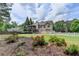 View of the back of the home showing the screened in porch and well manicured backyard at 1818 Mcconnell Rd, Grayson, GA 30017
