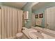 Full bathroom featuring a shower curtain, white sink, and light blue walls at 1818 Mcconnell Rd, Grayson, GA 30017