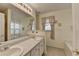 Bright bathroom featuring a double sink vanity, large mirror, and shower with curtain at 1818 Mcconnell Rd, Grayson, GA 30017