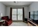 Bright room featuring a comfy chair, large window, and soft carpeting at 1818 Mcconnell Rd, Grayson, GA 30017