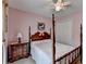 Bedroom with pink walls, a four poster bed, and a closet at 1818 Mcconnell Rd, Grayson, GA 30017
