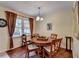 Warm dining room with wood floors, round table, and a large window offering a pleasant view at 1818 Mcconnell Rd, Grayson, GA 30017