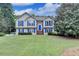 Charming two-story home featuring blue shutters and a well-manicured lawn at 1818 Mcconnell Rd, Grayson, GA 30017